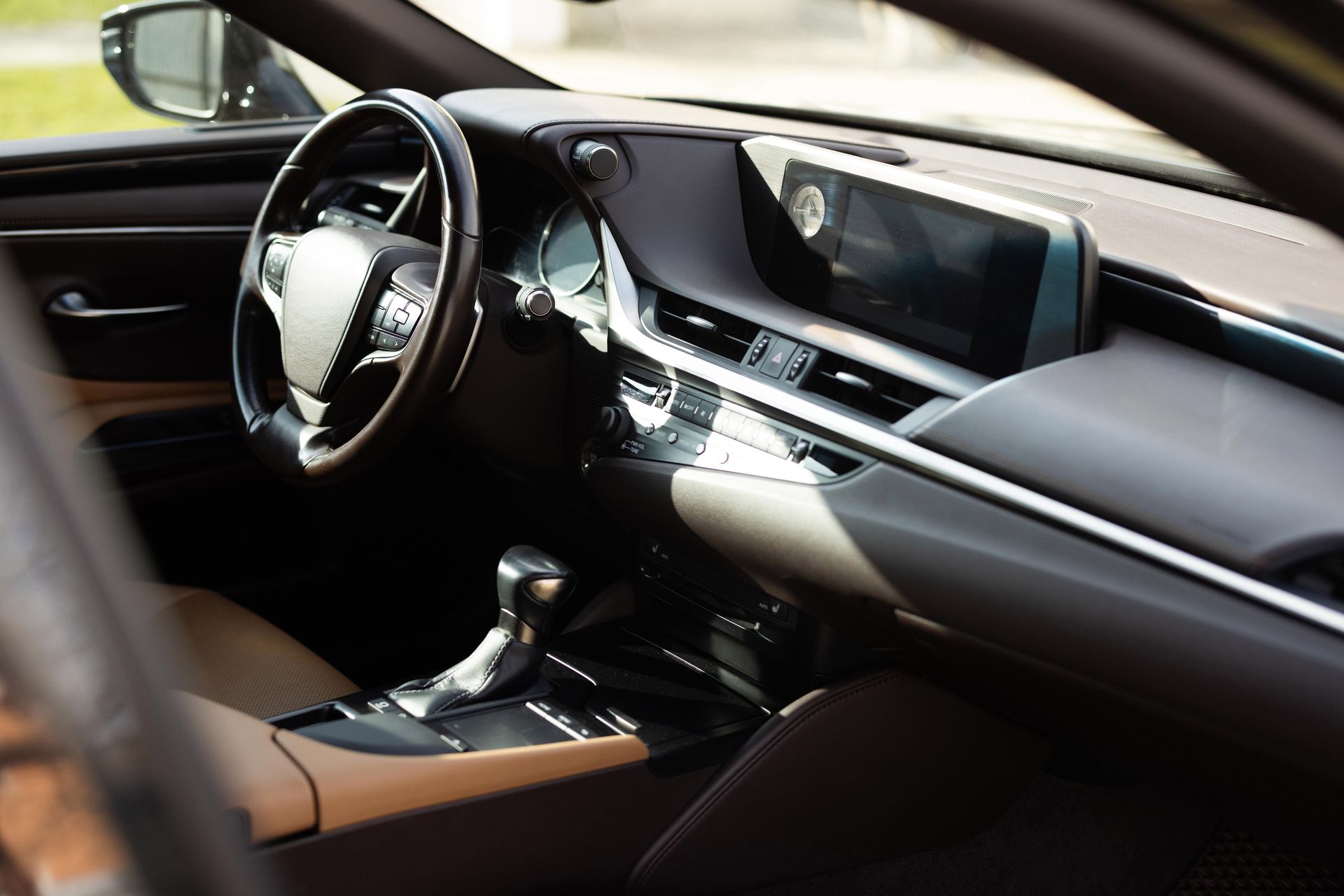 The interior of a car with a steering wheel and dashboard.