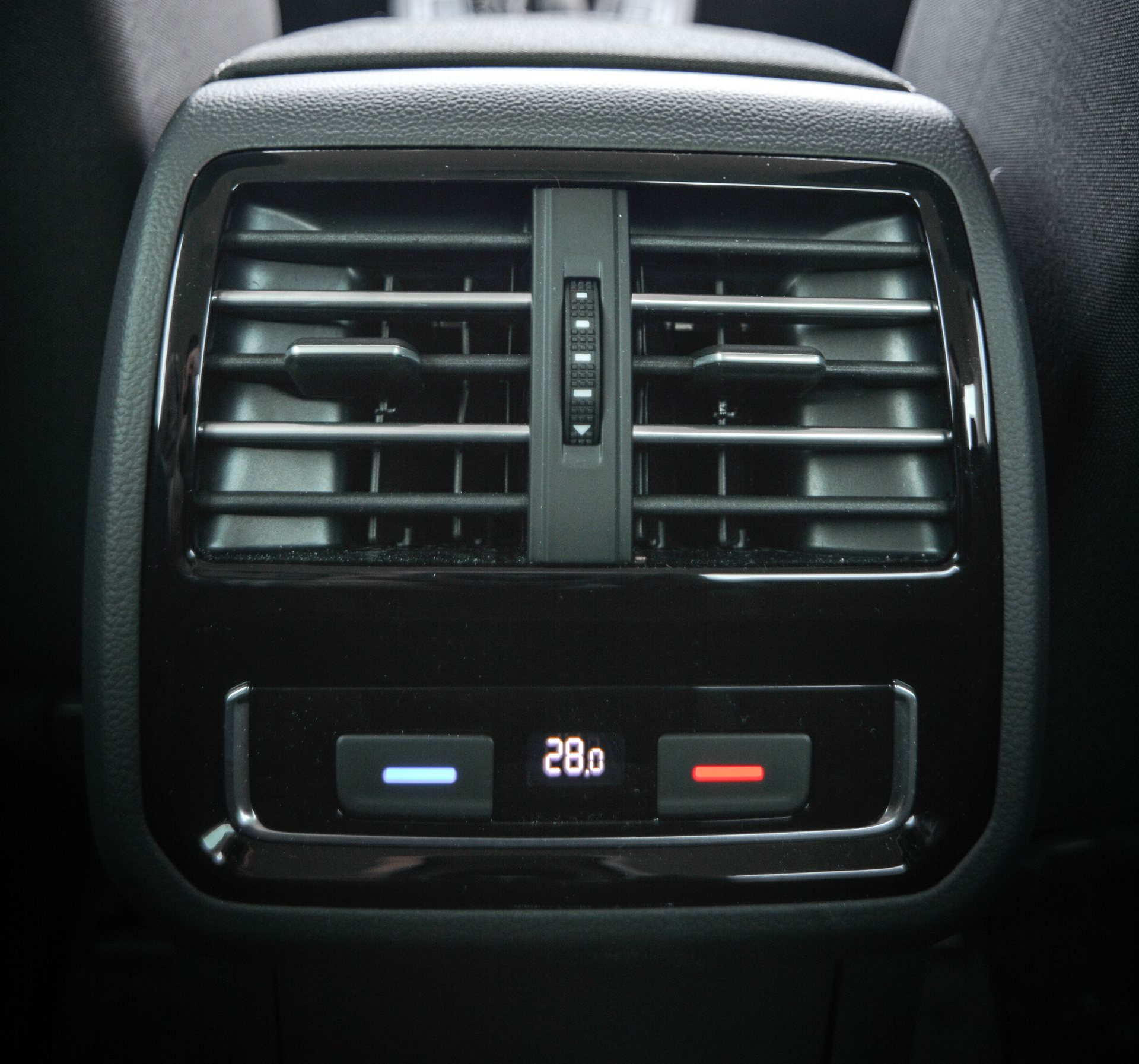 A close up of the rear air vent in a car.