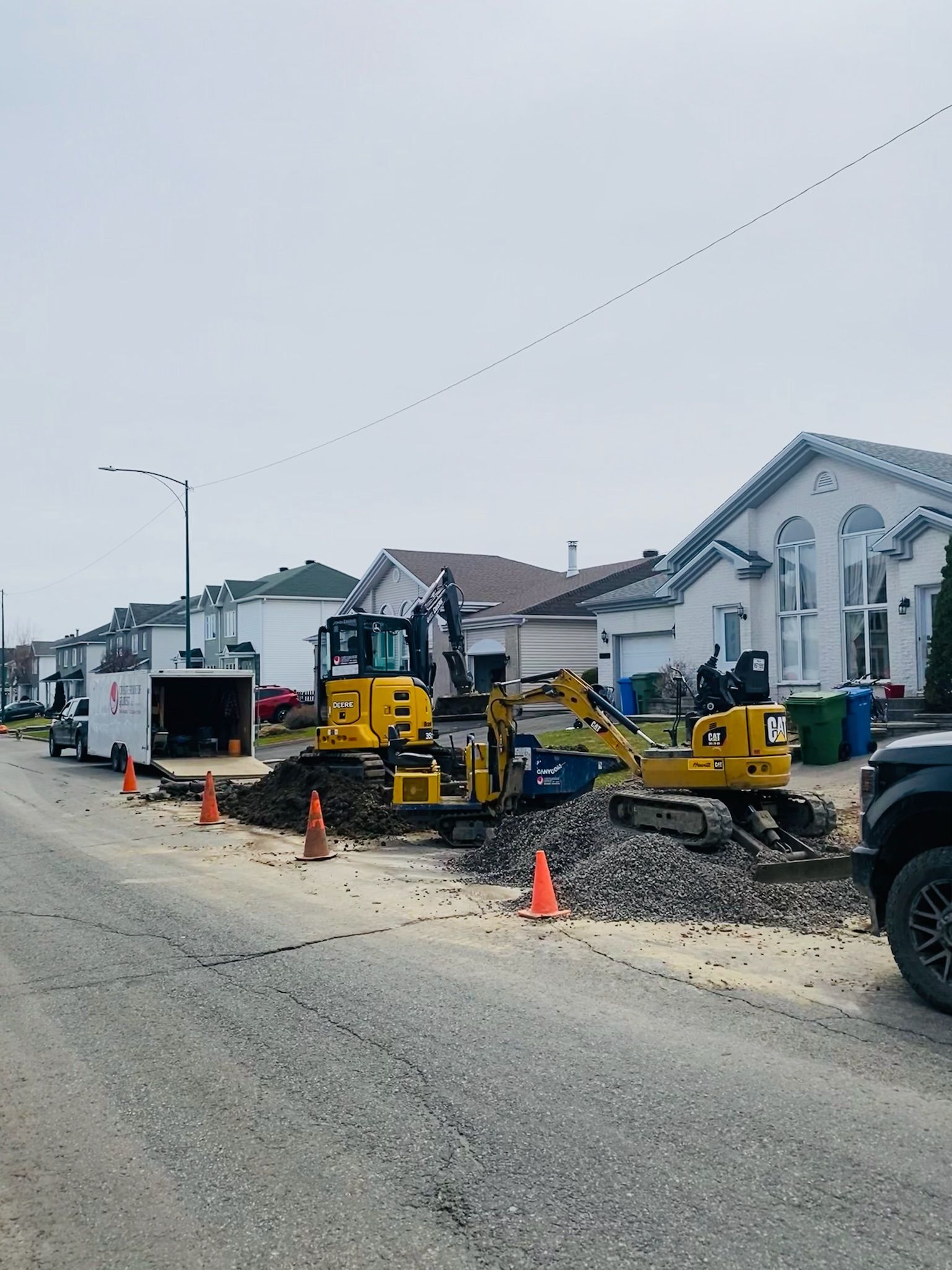 Un camion est garé sur le bord de la route devant un chantier de construction.