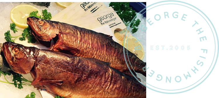 A picture of smoked fish with a stamp that says george the fishmonger