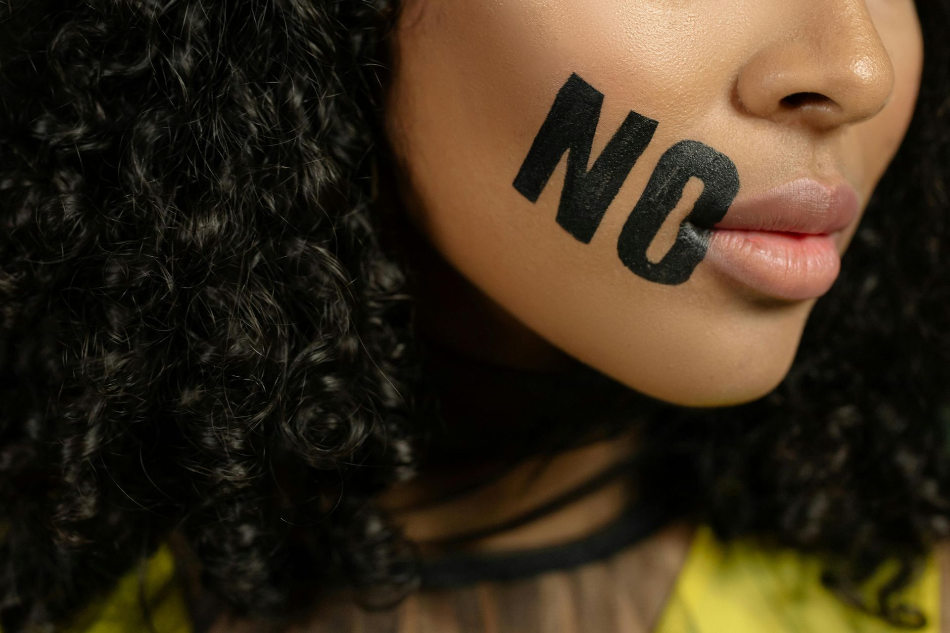 A woman with the word no painted on her face.