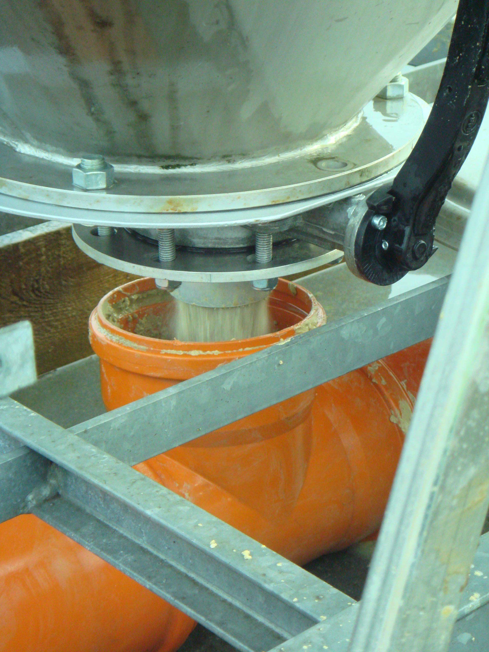 A close up of a machine with orange pipes coming out of it