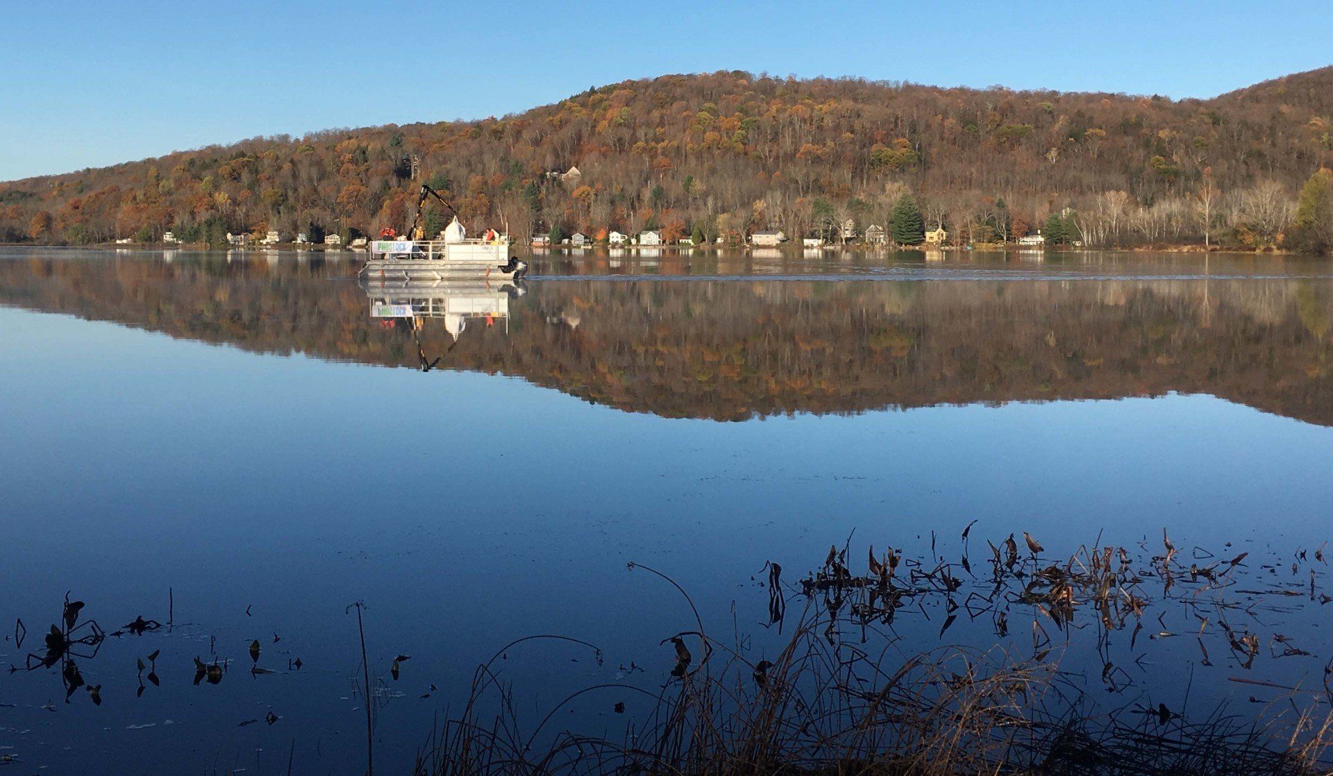 A lake with a mountain in the background and a reflection of a mountain in the water.