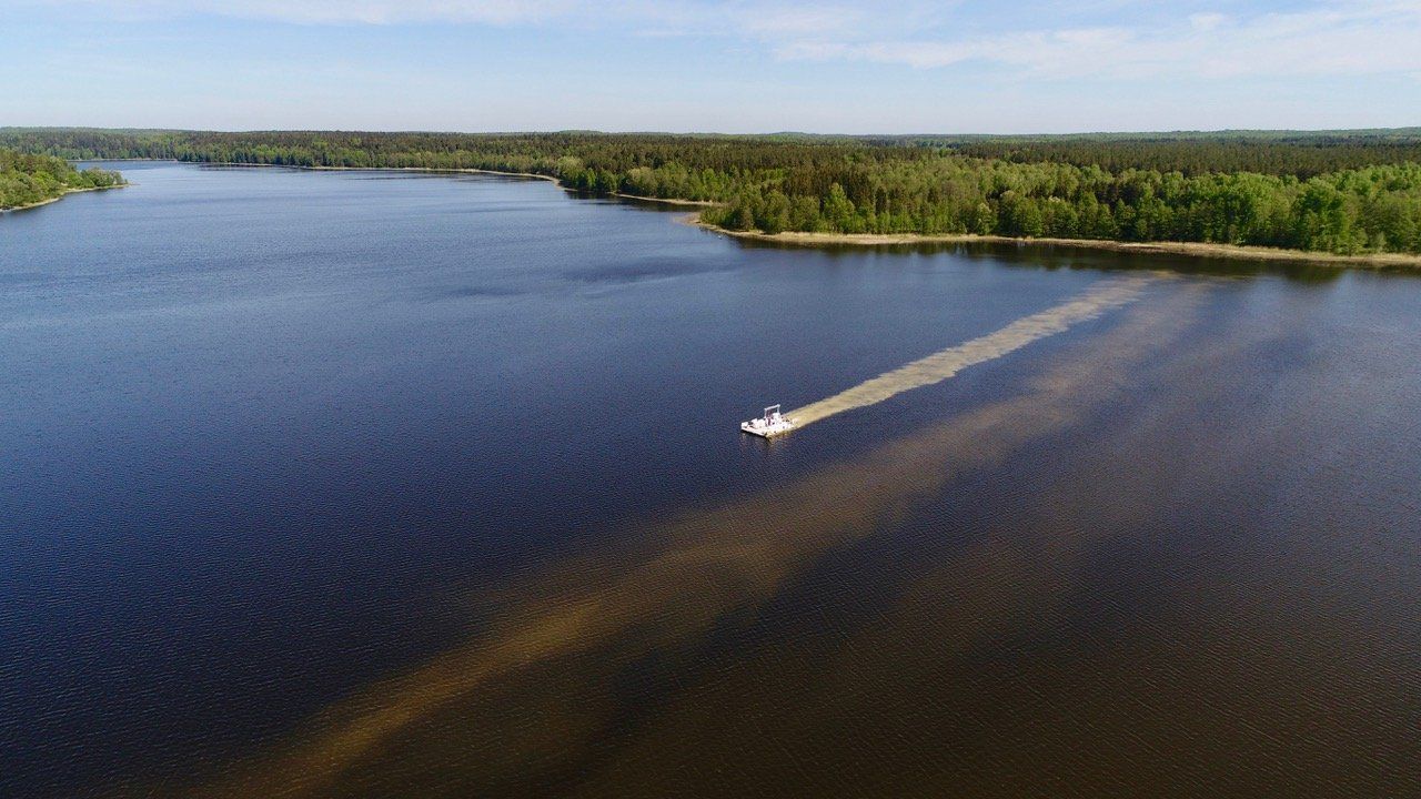 An aerial view of a boat floating on top of a large body of water.