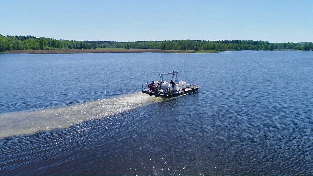 A boat is floating on top of a large body of water.