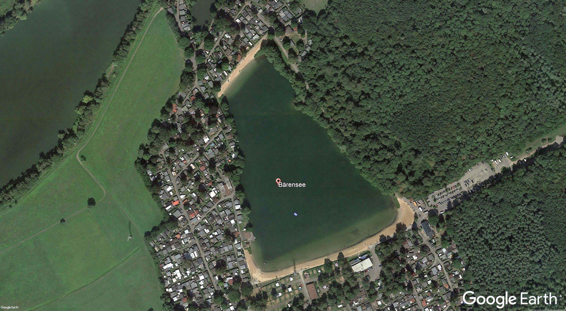 An aerial view of a large body of water surrounded by trees.