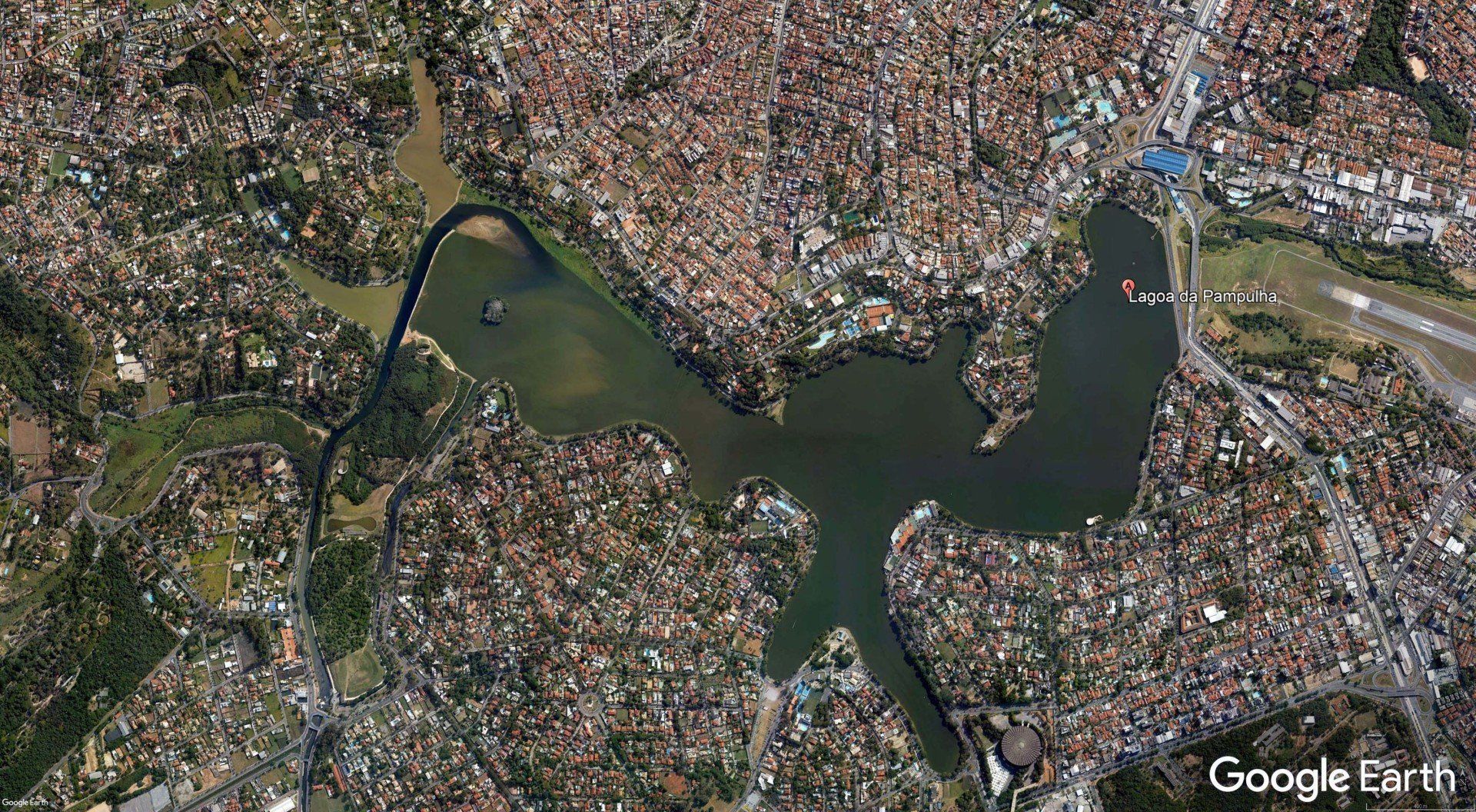 An aerial view of a large body of water surrounded by a city.