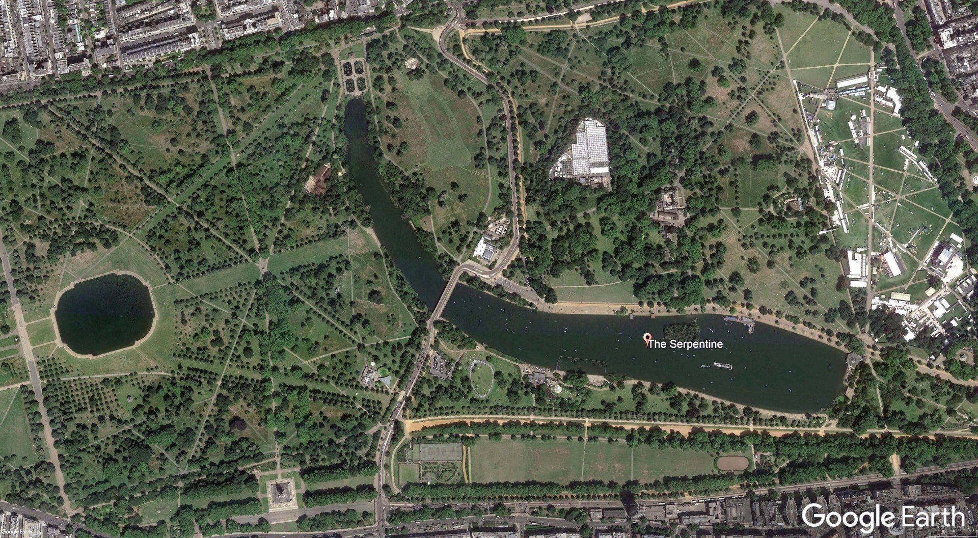 An aerial view of a park with a river running through it