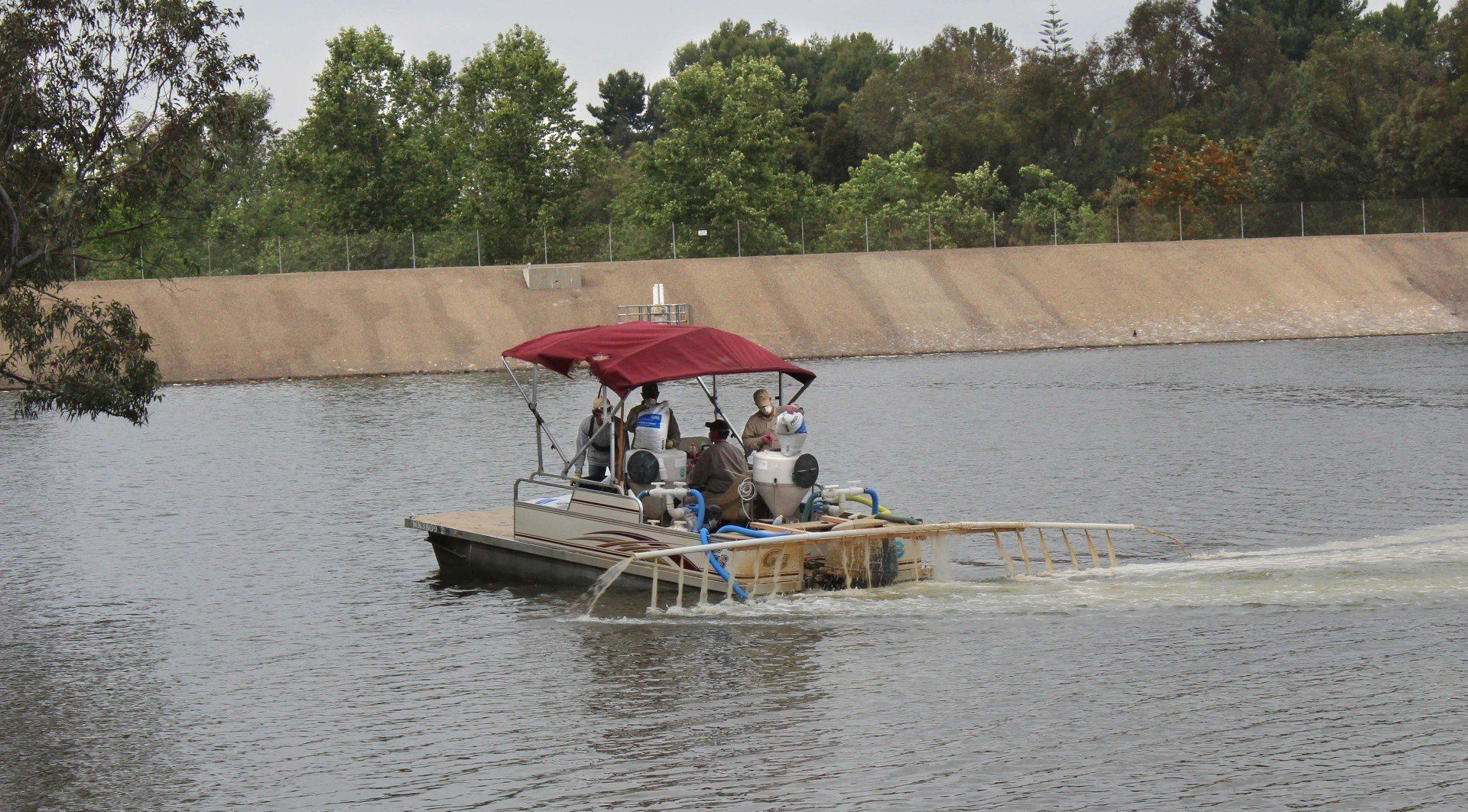 A boat with a red canopy is floating on a lake