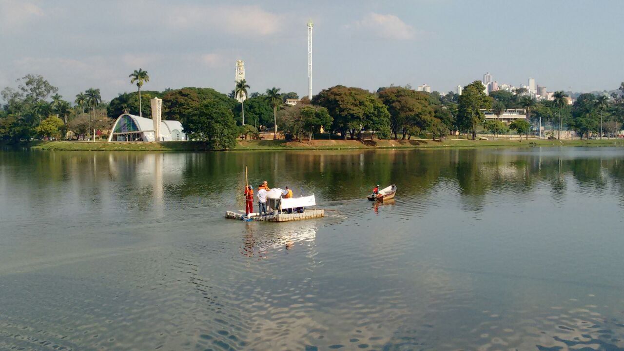 A group of people are floating on a raft in a lake.