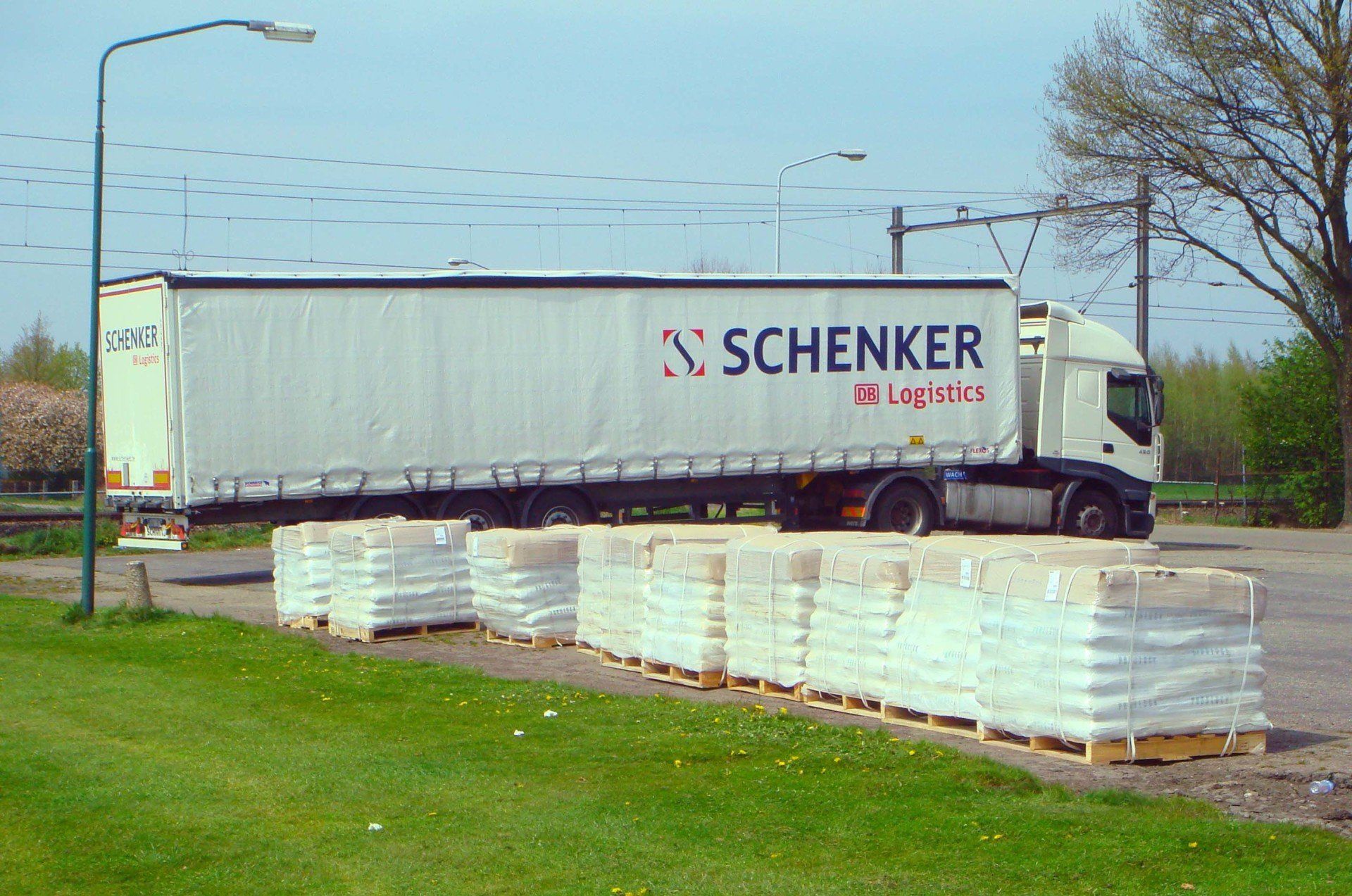 A schenker truck is driving down the road