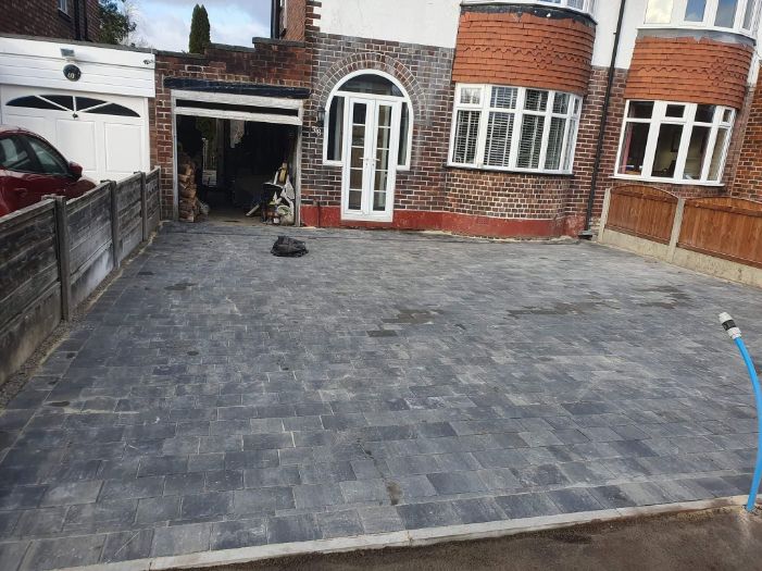 A driveway is being built in front of a house.