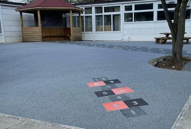 A playground with a hopscotch game painted on the ground