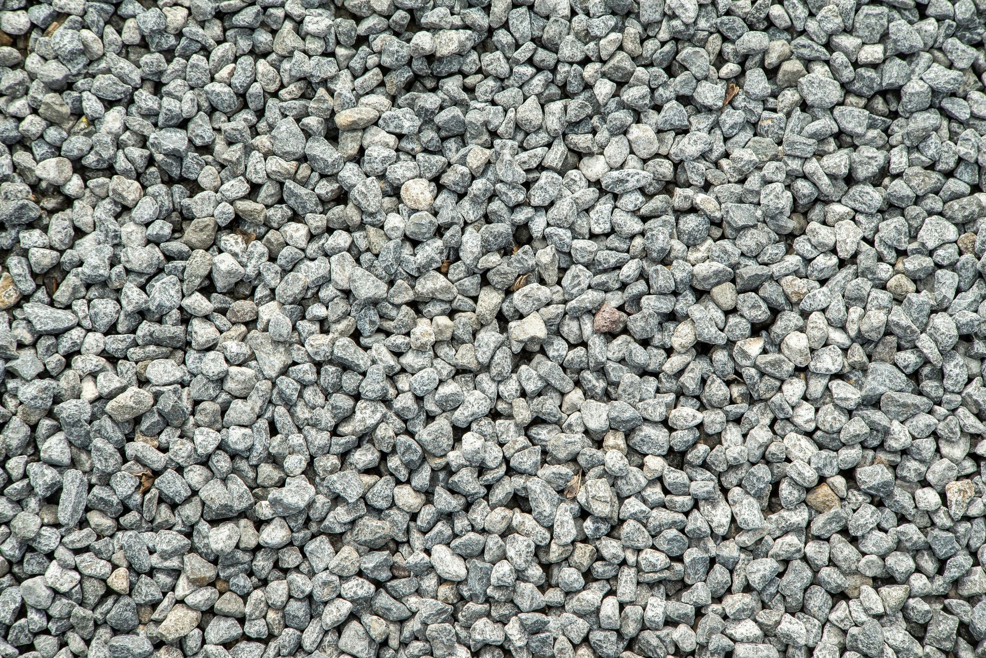 A pile of gravel is sitting on the ground.