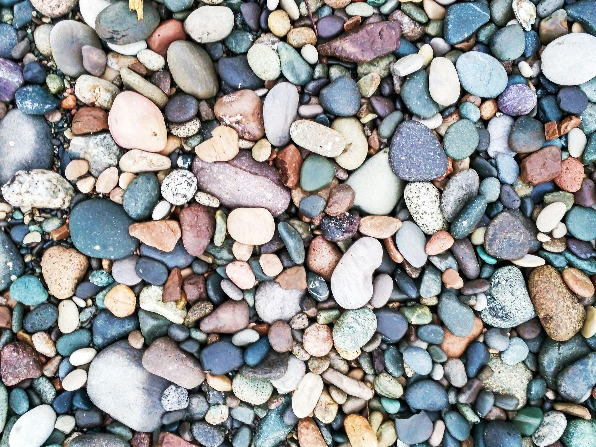 A pile of colorful rocks on a beach.