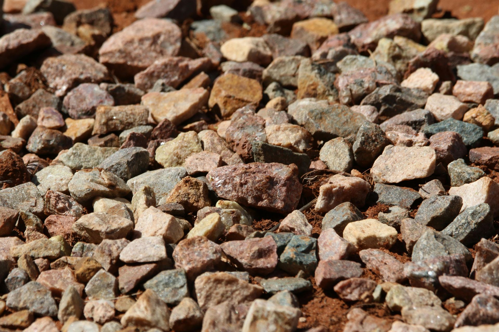 A pile of rocks is sitting on the ground.