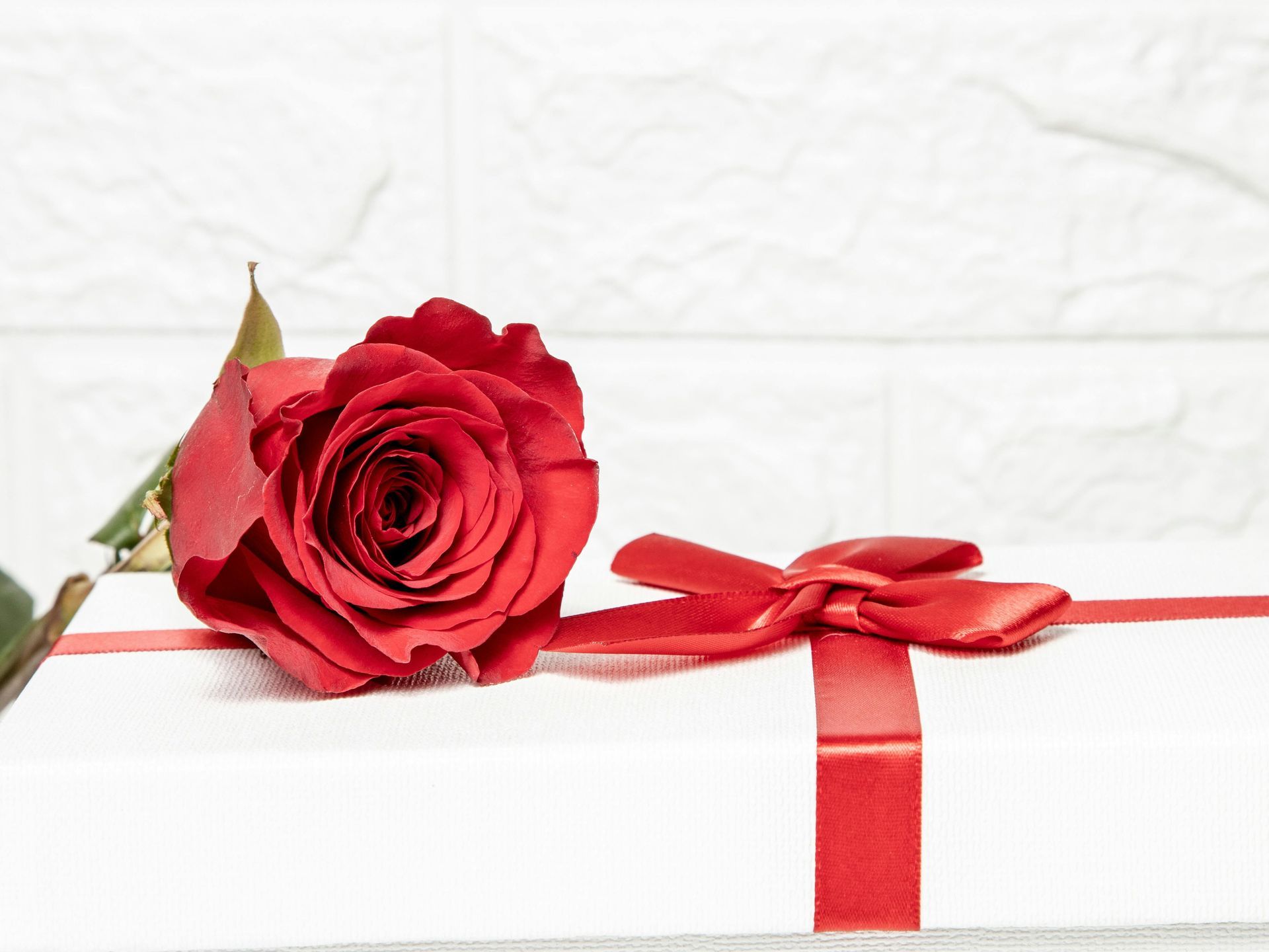 A rose on a wrapped present.