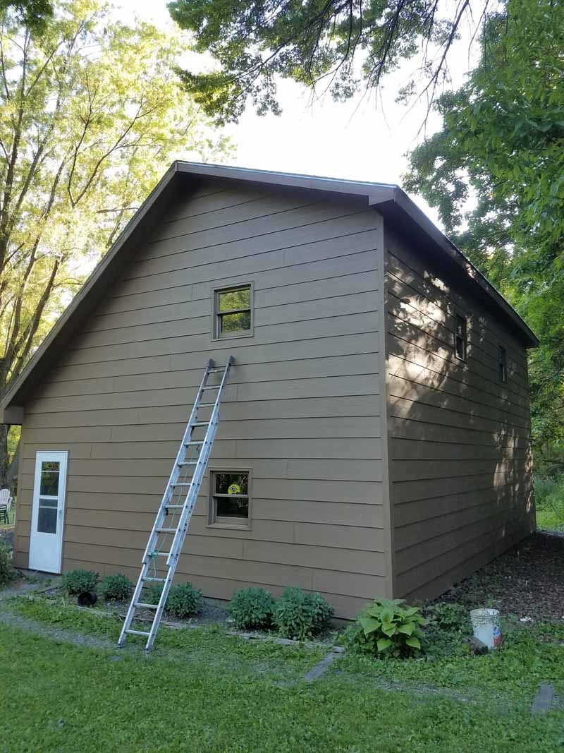 A ladder is leaning against the side of a house.