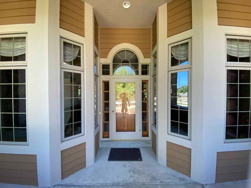 The front door of a house with a lot of windows