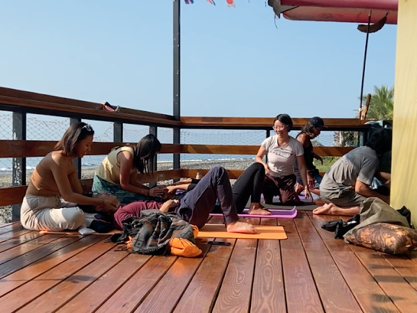 A group of people are sitting on a wooden deck