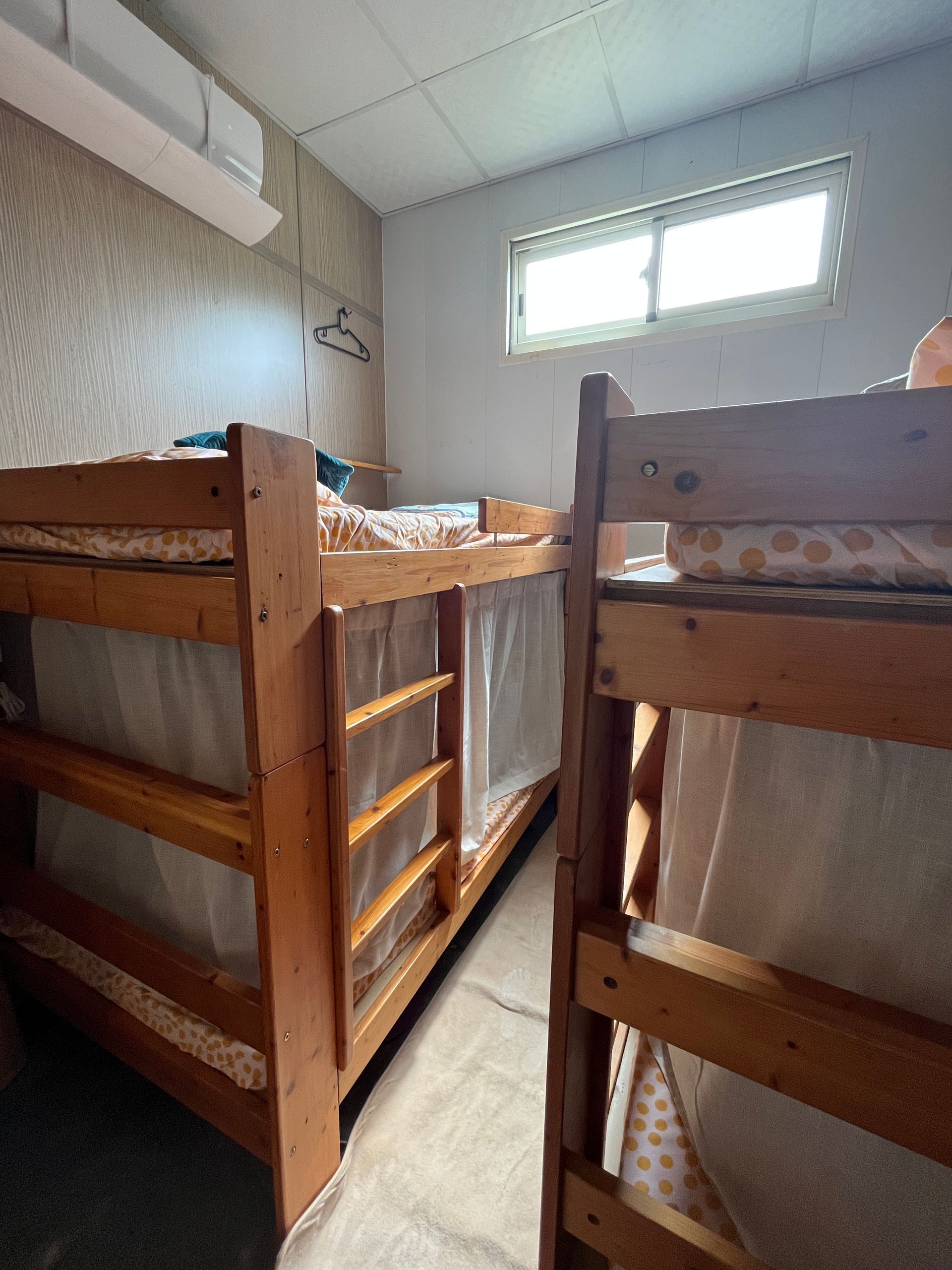 Two bunk beds are sitting next to each other in a room.