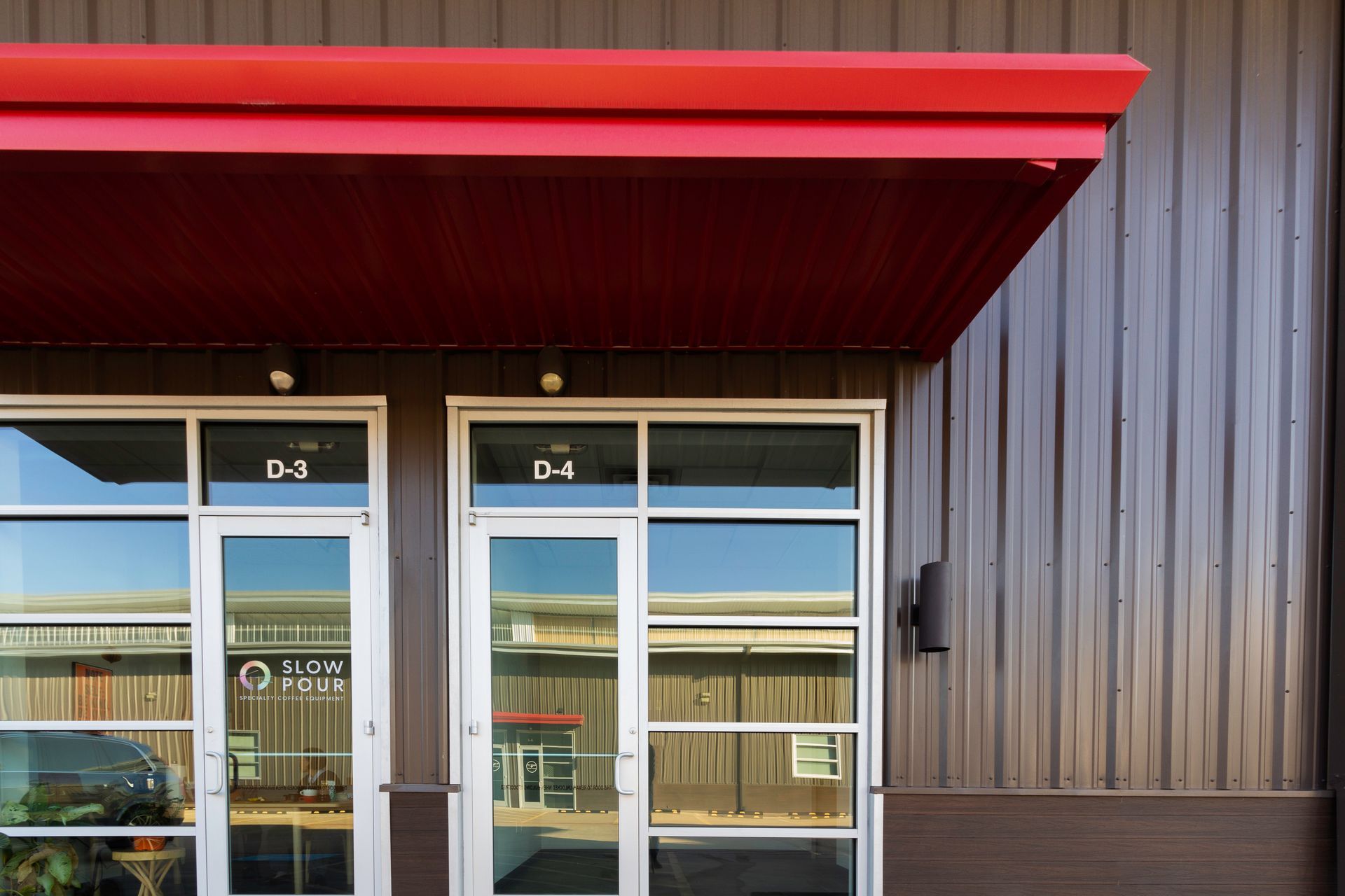A building with a red awning on top of it