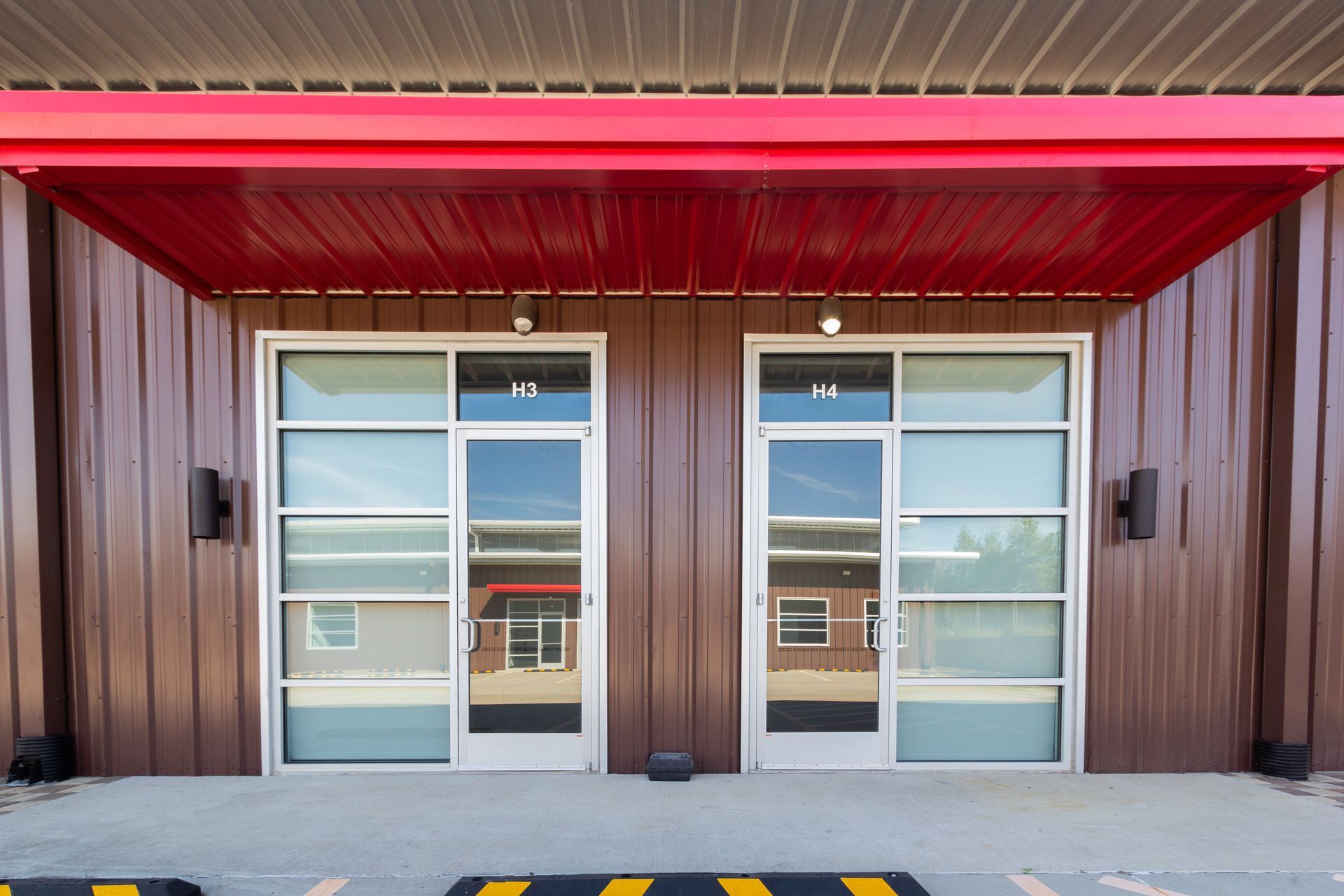 A building with two doors and a red roof