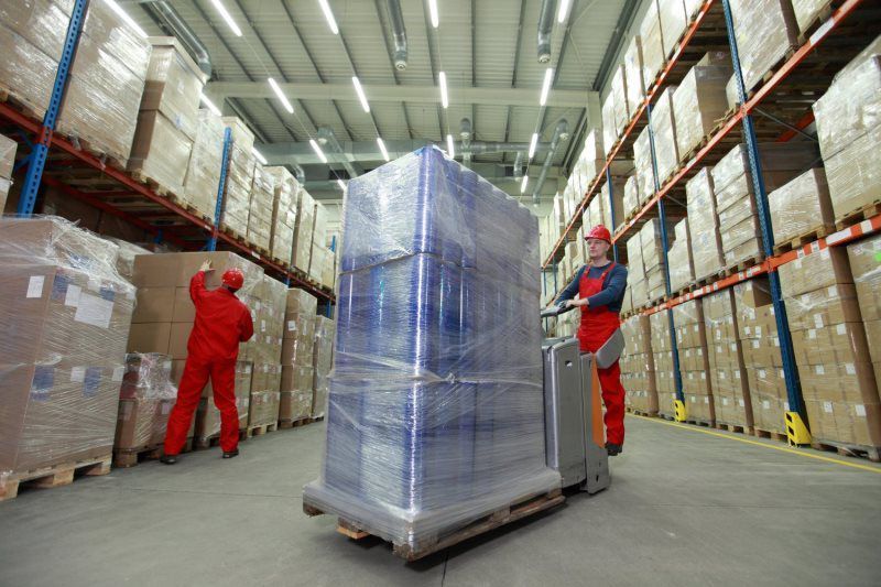 Workers arranging boxes on a warehouse