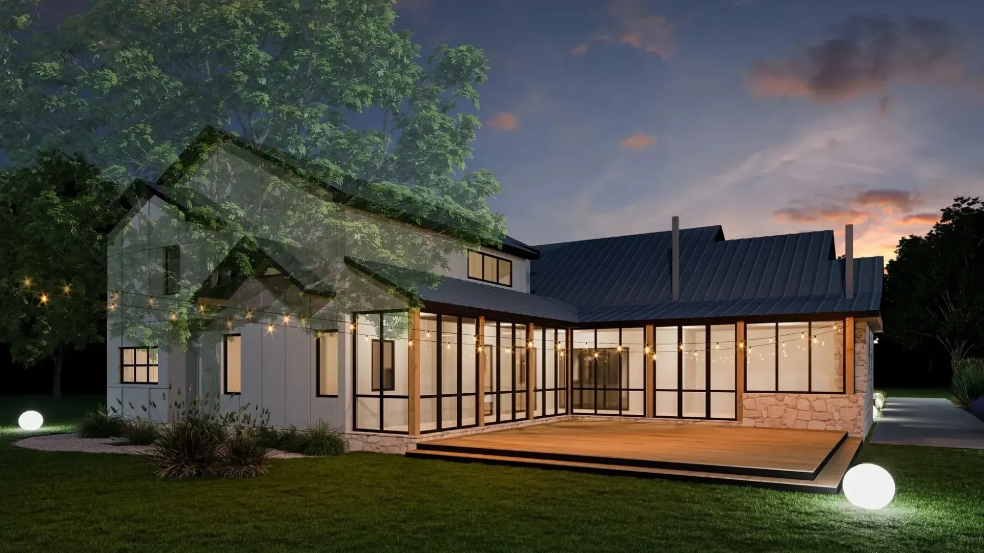 Rear view of a modern two-story home with a deck, lit by string lights and orbs at dusk.