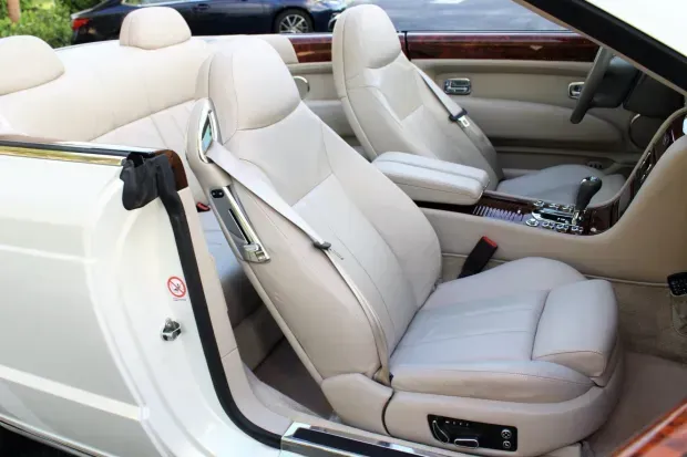 Exotic Limo Orlando Cream leather interior of a white convertible car, open door.