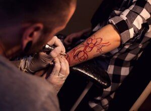 Tattoo Artist Works In Salon — Tattoo shop in Reno, NV