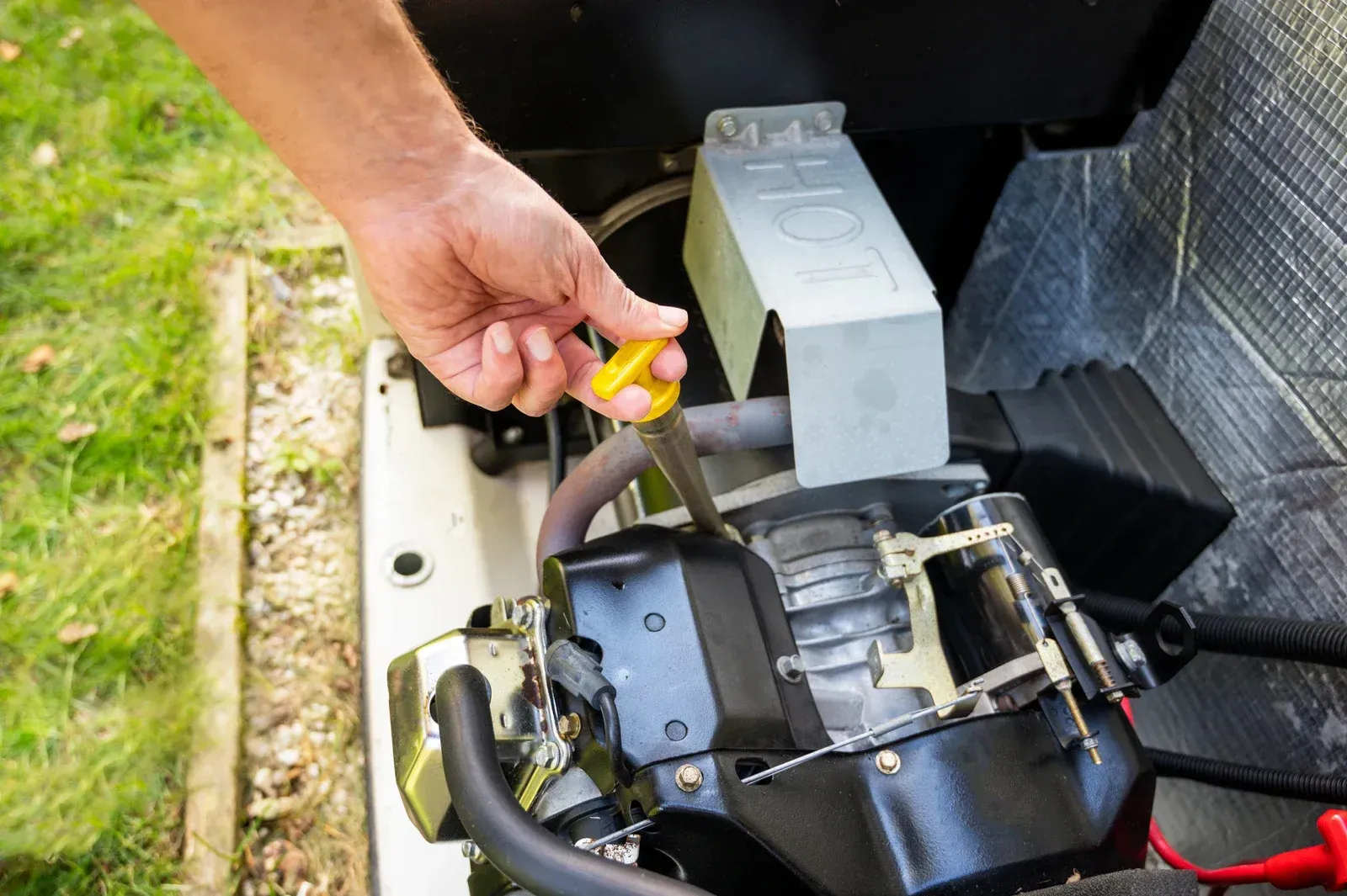 A person is using a screwdriver to fix a generator.
