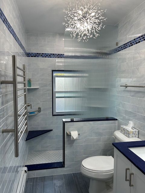 A bathroom with a toilet a sink and a shower