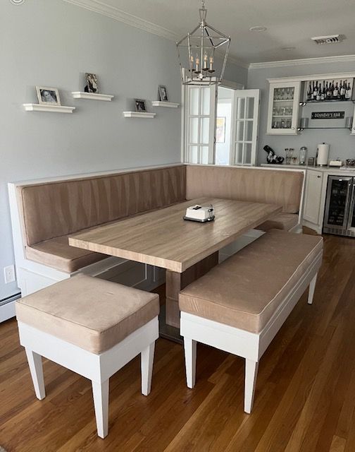 A dining room with a table and two benches