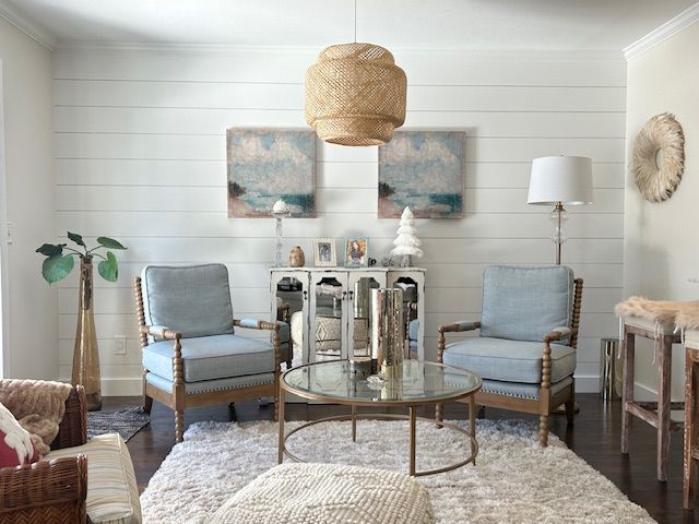 A living room with two chairs and a coffee table.