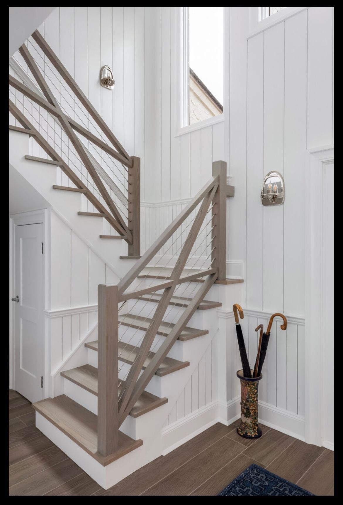 A staircase with a wooden railing in a hallway