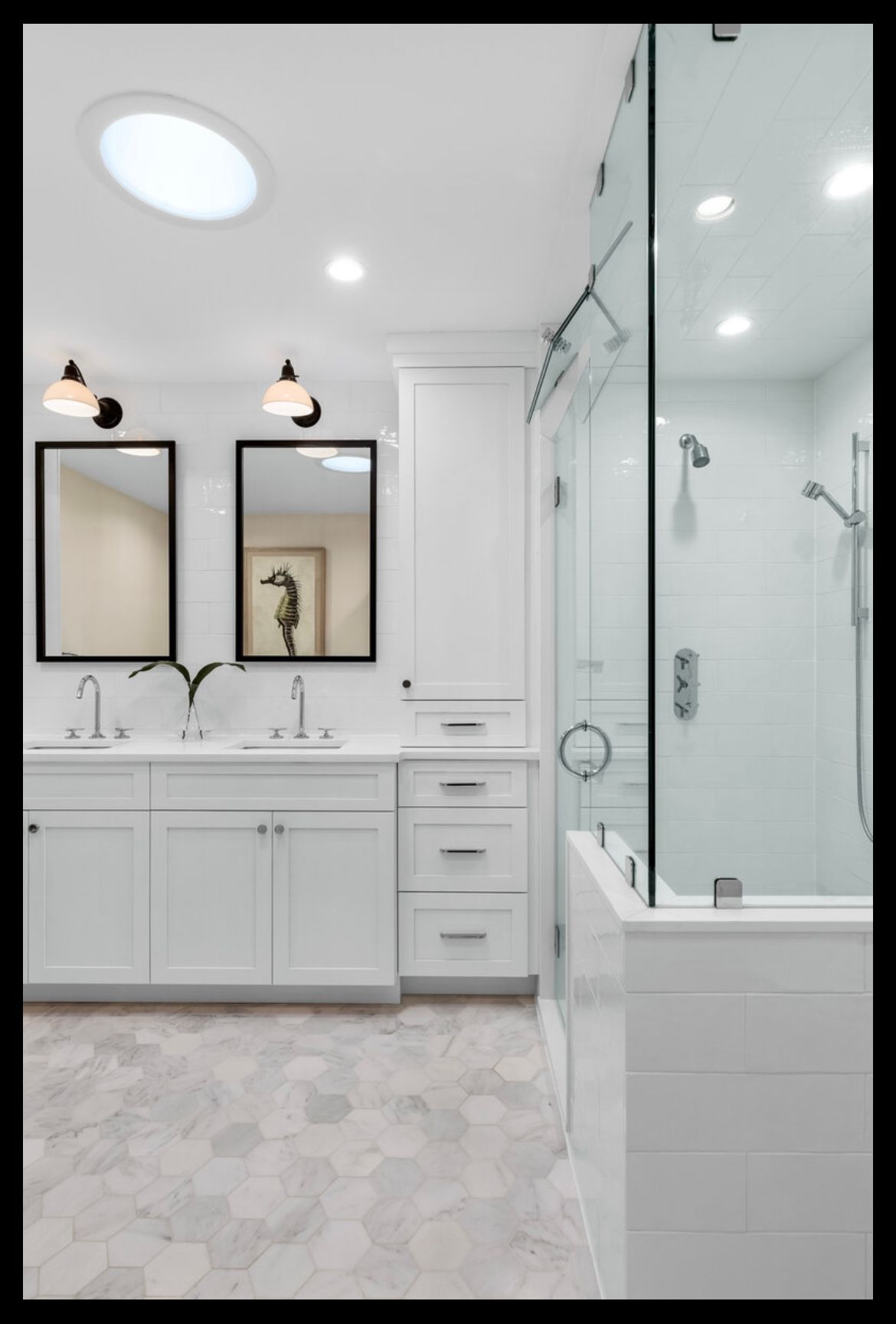 A bathroom with two sinks and a walk in shower.