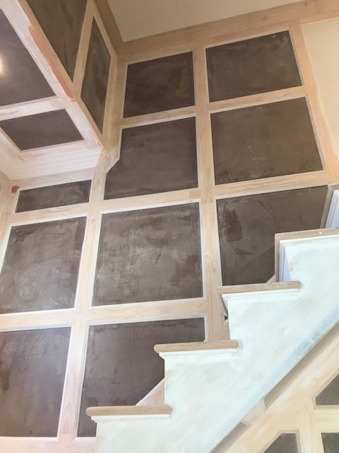 A staircase in a house with squares on the wall
