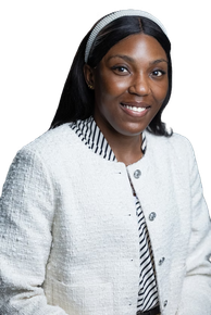 A woman wearing a white jacket and a headband is smiling.