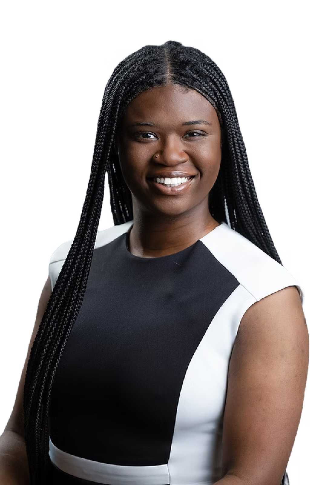 A woman with braids is wearing a black and white dress and smiling.