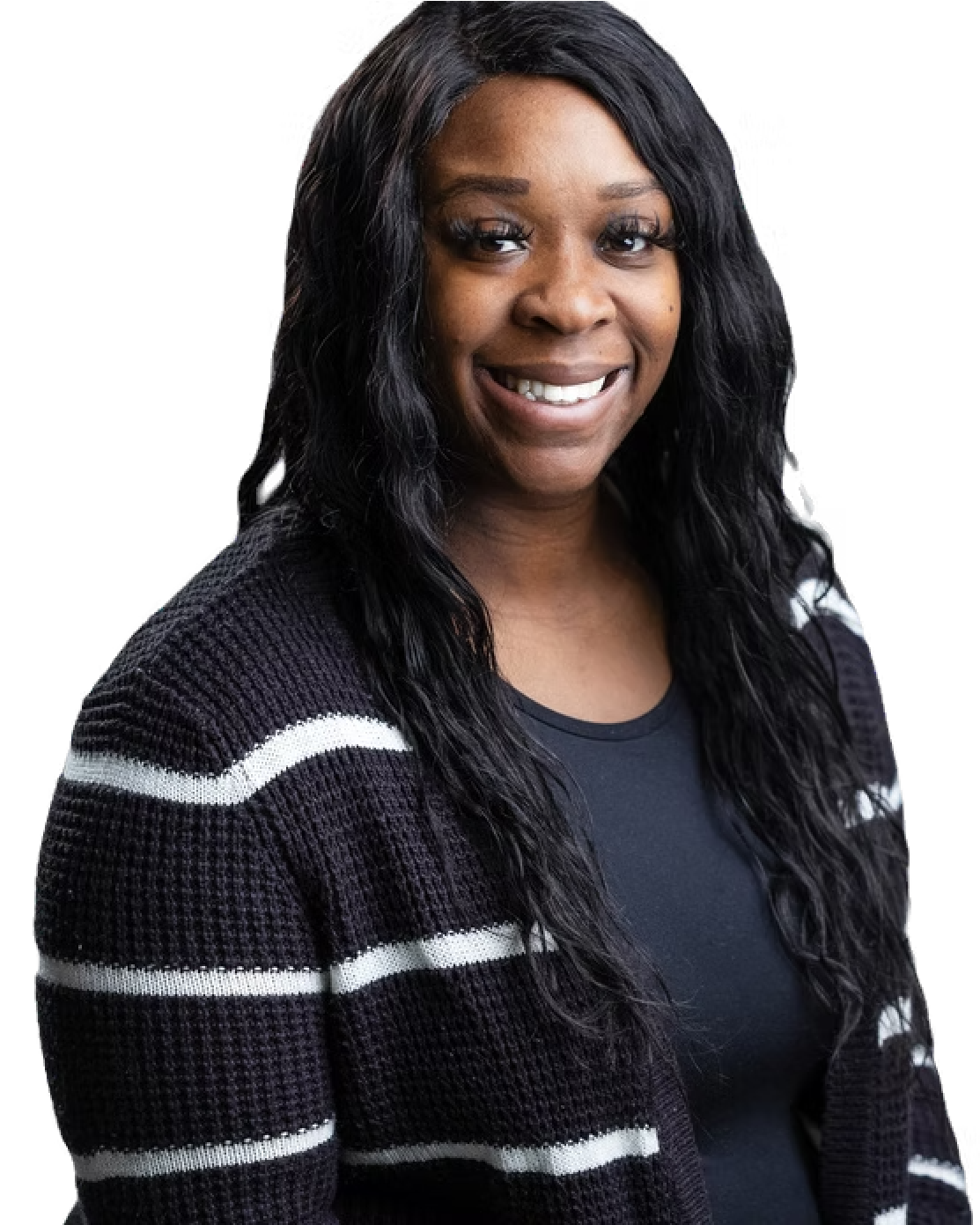 A woman is wearing a black and white striped sweater and smiling.