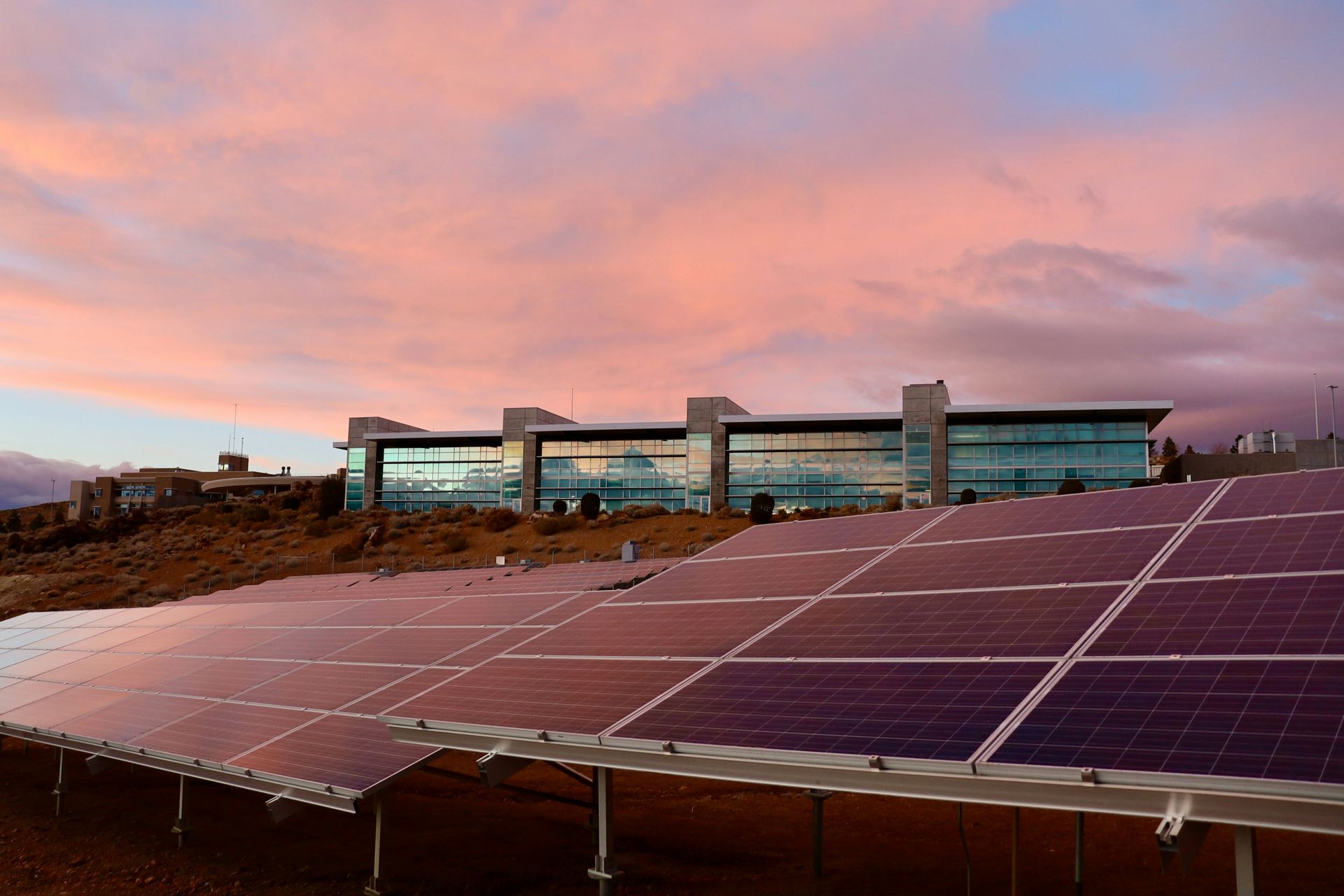 A large building with a lot of solar panels in front of it.