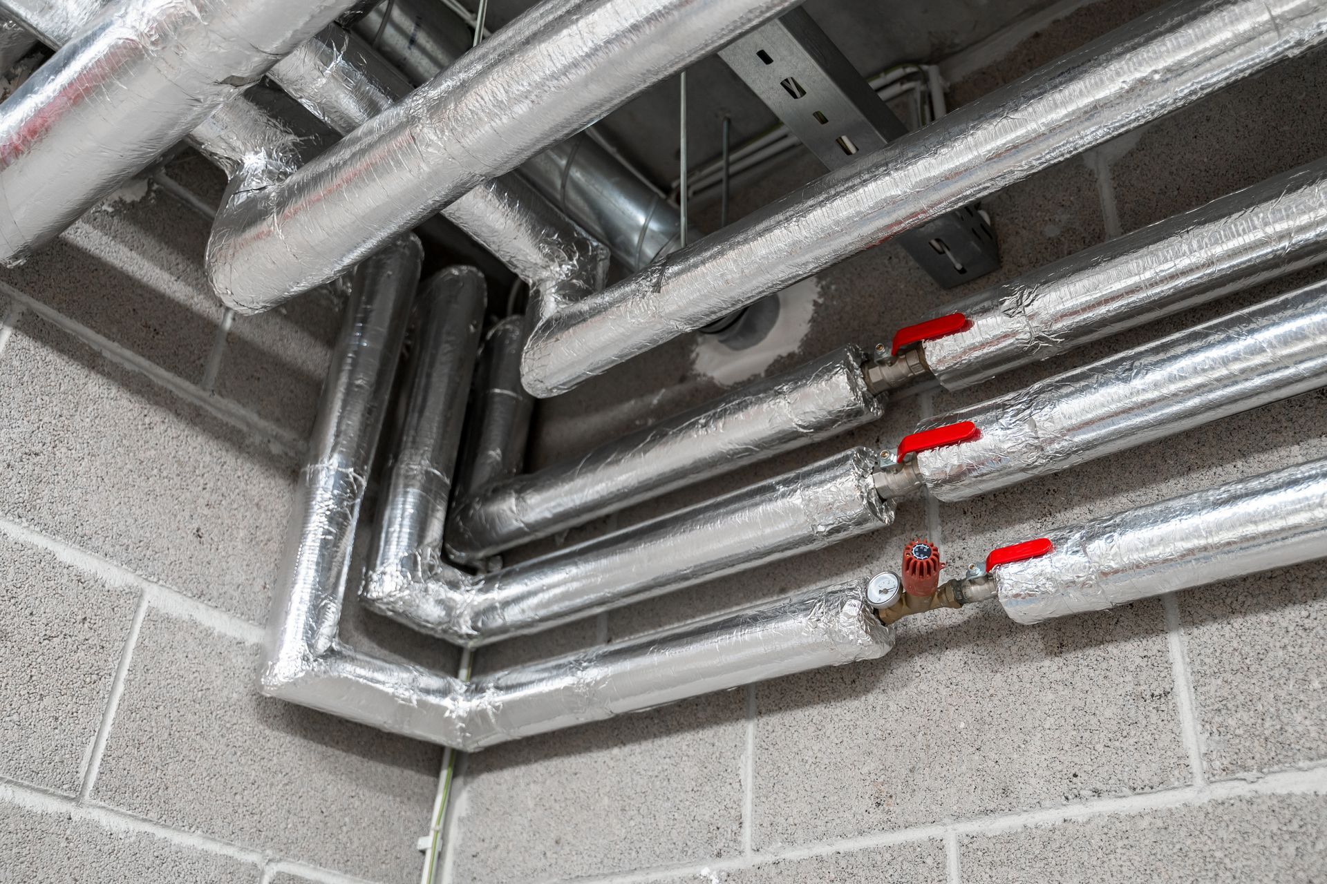 team piping system insulation on building pipes with shutoff valves to improve energy efficiency. team piping system insulation on building pipes with shutoff valves to improve energy efficiency.