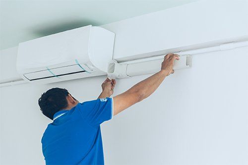 A Person Installing Air Conditioner