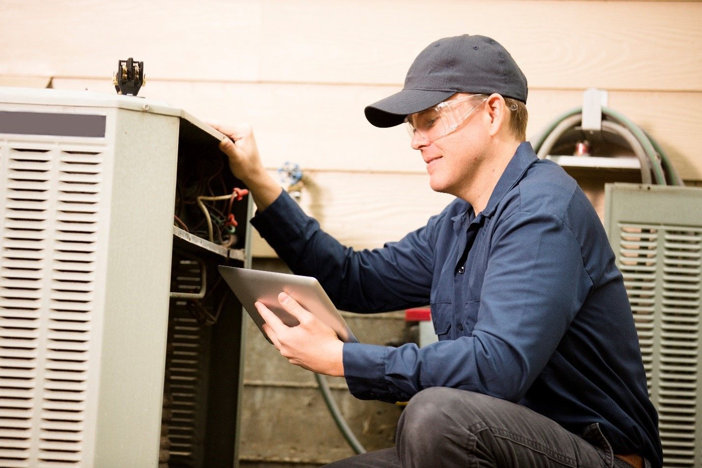 Man Working on an Air Conditioner — Mississippi — CJ Services Inc.