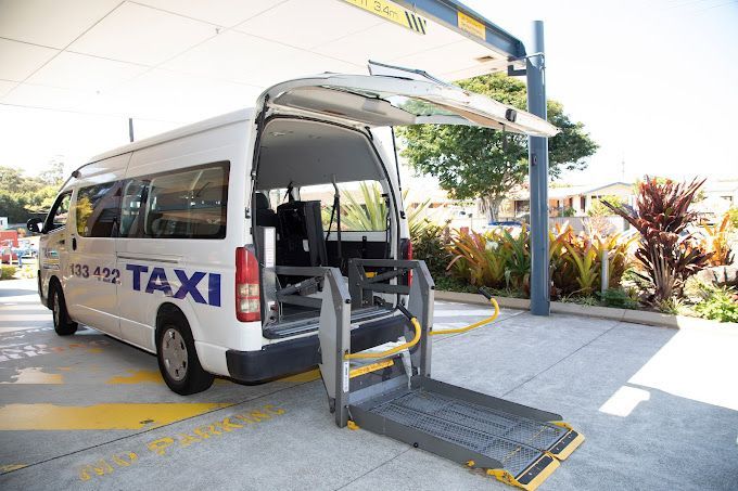 A Man is Talking to Another Man in a Car — Tweed Heads Coolangatta Taxi Service In Tweed Heads, NSW