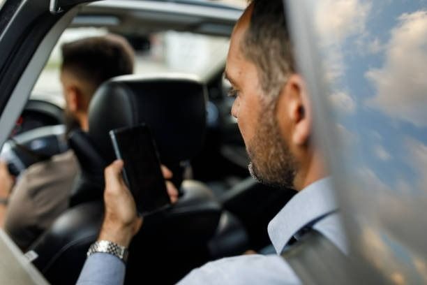 A Man Is Pushing A Man In A Wheelchair Into A Van — Tweed Heads Coolangatta Taxi Service In Kirra, QLD