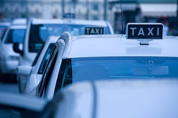 A Row of White Taxis Are Parked Next to Each Other — Tweed Heads Coolangatta Taxi Service In Tweed Heads South, NSW
