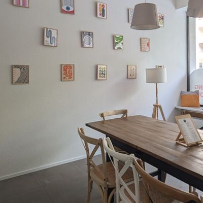 Large wooden table and decorated wall.