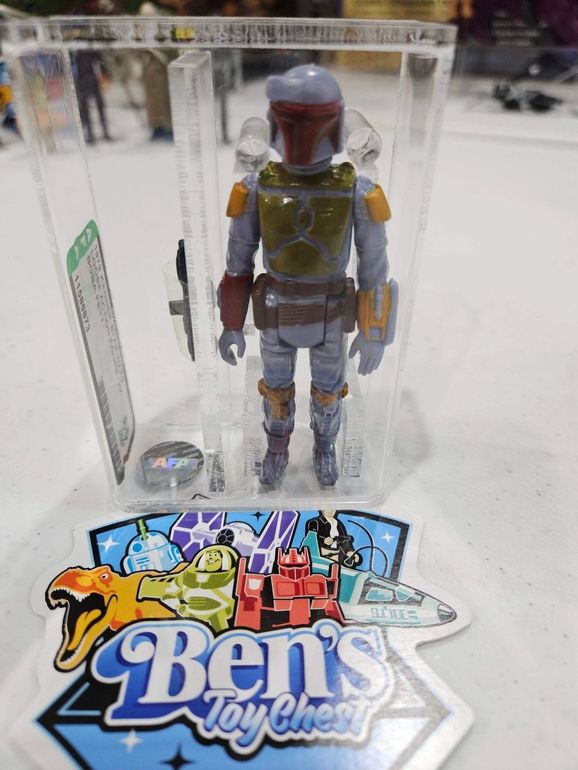 Boba Fett action figure in clear case with Ben's Toy Chest logo, on a white surface.